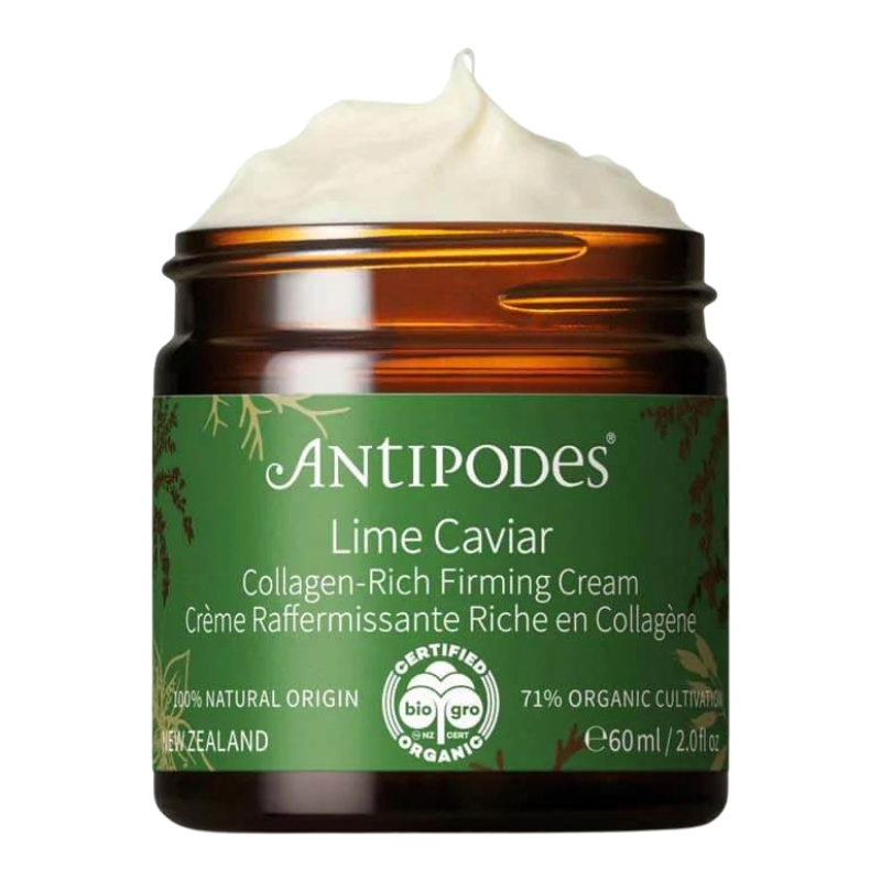 An amber glass jar of Antipodes Lime Caviar Collagen-Rich Firming Cream with a green label and a swirl of white cream visible at the top, on a white background.