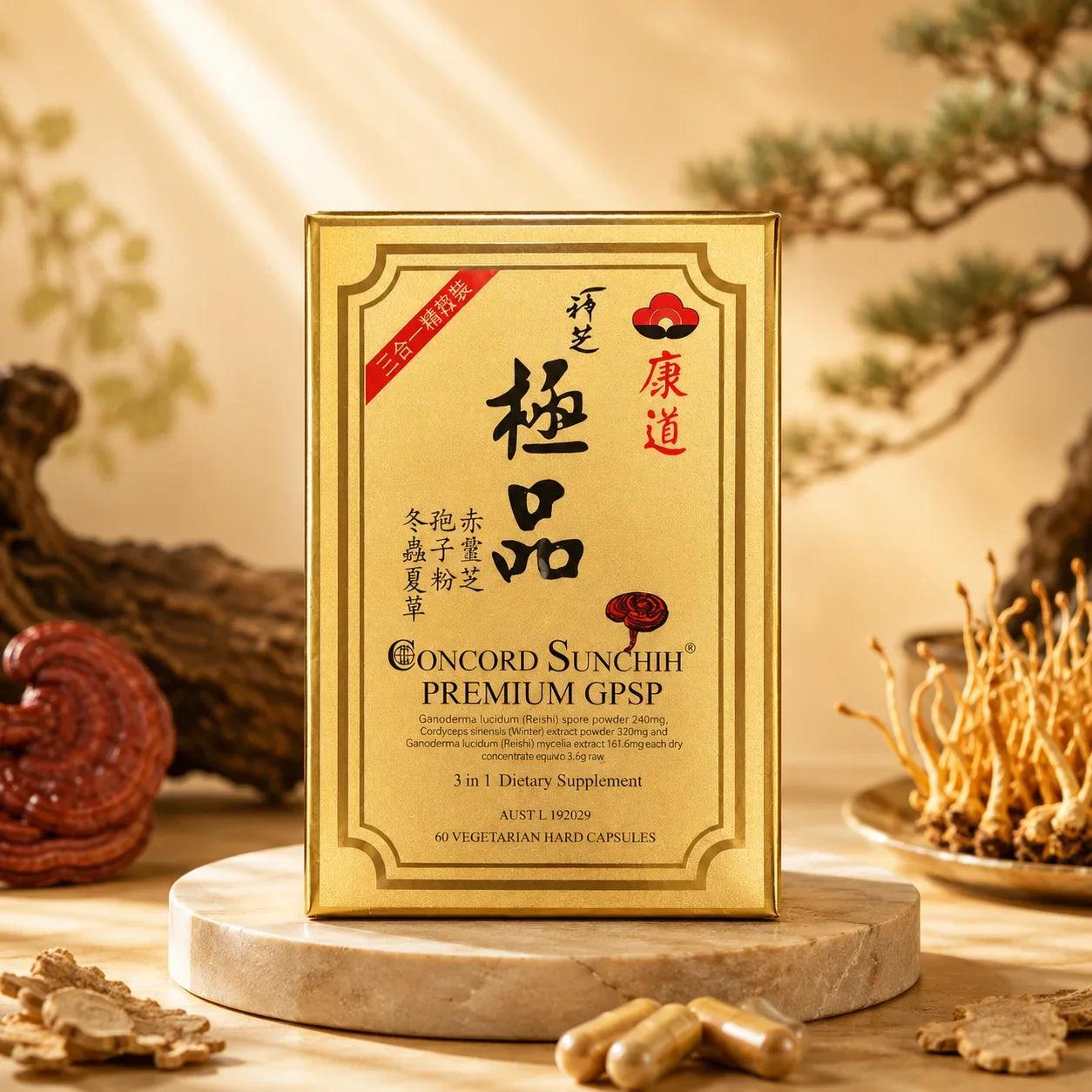 A gold rectangular box of Concord Sunchih Premium GPSP dietary supplement stands on a round stone pedestal. The box features Chinese characters, a red brand logo, and English text.