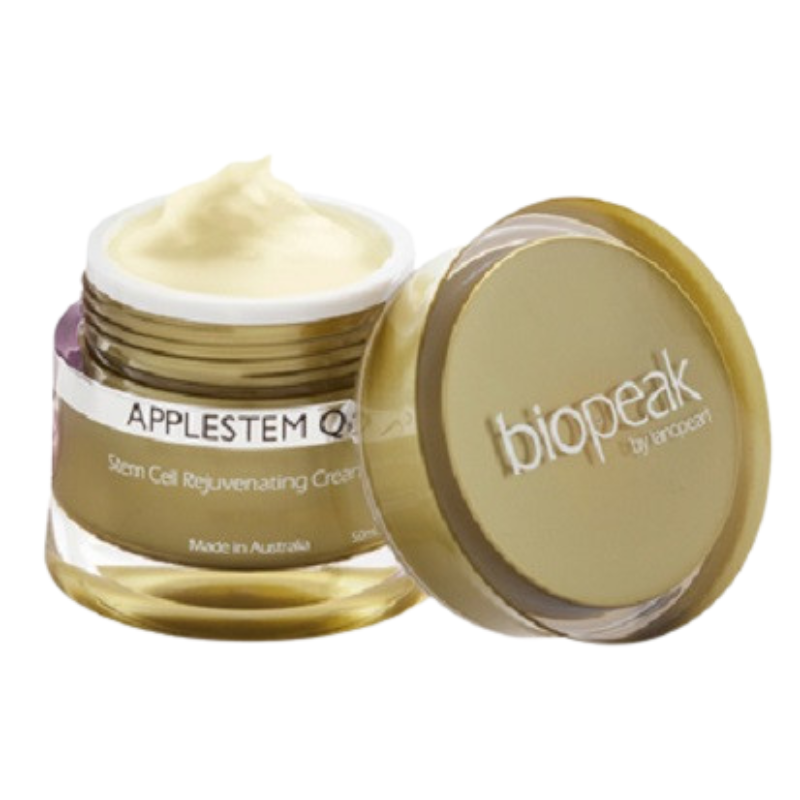 An open jar of Biopeak by Arcosen Applestem Q10 Stem Cell Regenerating Cream, showing the white cream inside, with its gold lid leaning against it on a white background.
