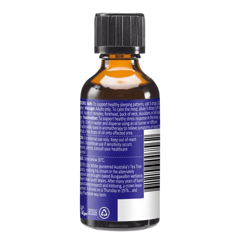 An amber glass bottle with a black cap, showing the back label with white text and a prominent purple section, photographed on a white background.