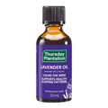 A 50 mL bottle of Thursday Plantation Lavender Oil on a plain white background. The bottle is made of amber glass, has a black ribbed cap, and features a purple label with green and white text.