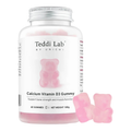 A bottle of Teddi Lab by Unichi Calcium Vitamin D3 Gummy, featuring a white label with a pink gummy bear graphic and three loose pink gummies displayed in front on a white background.
