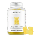 A bottle of Teddi Lab by Unichi Omega-3 DHA Gummy supplements with a white label and silver cap, shown alongside three yellow gummy bears on a white background.