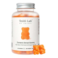 A bottle of Teddi Lab By Unichi Turmeric Extract Gummy, containing orange gummy bears, with three loose orange gummies placed in front on a white background.